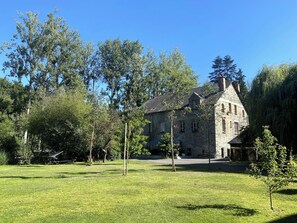 A stone building with a traditional architectural style, surrounded by a well-maintained lawn and trees. - House on the Riverbank in Downtown with a Pool (Vitré)