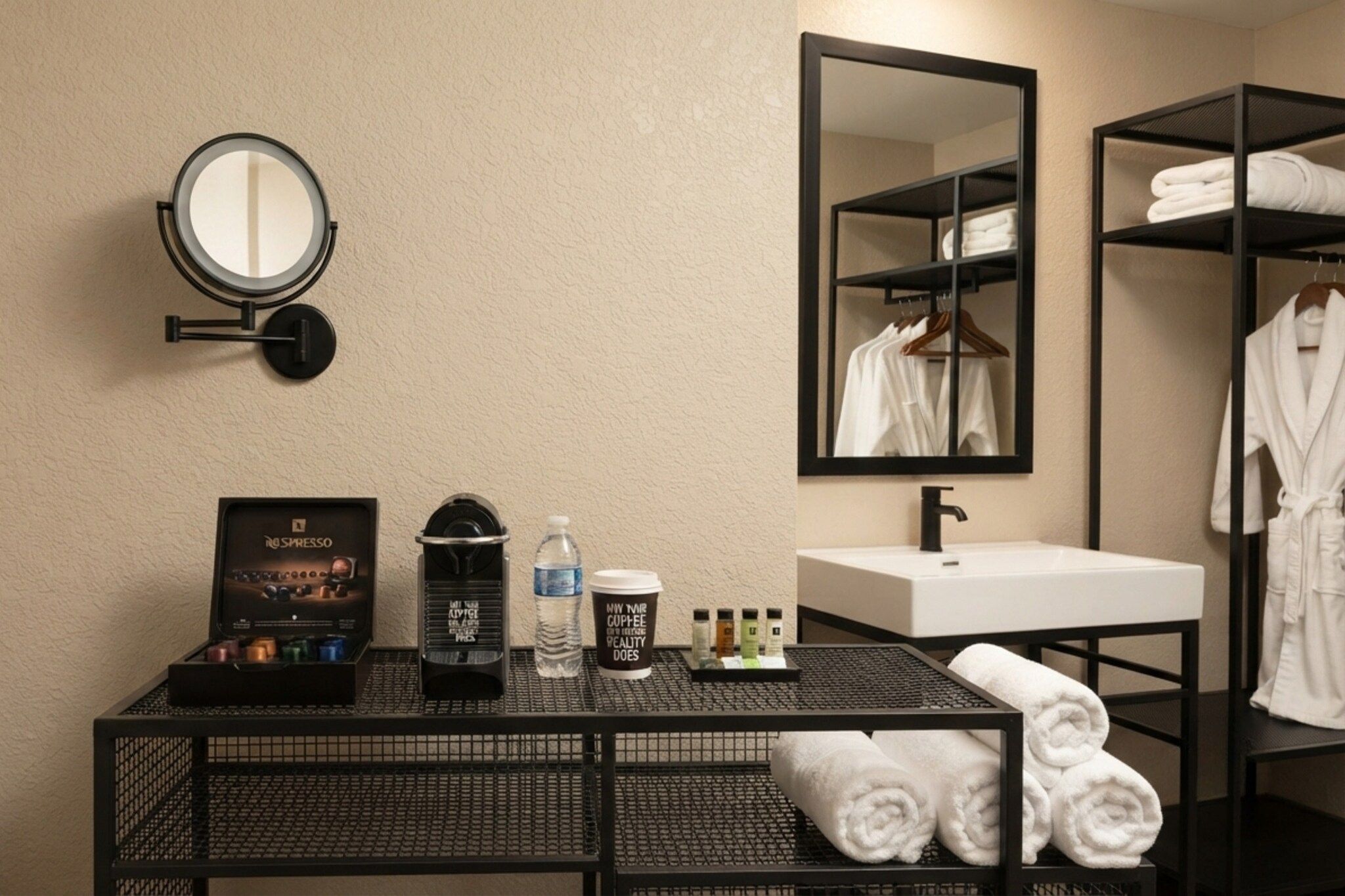 Une salle de bain d’hôtel avec un lavabo, un miroir et un porte-serviettes.