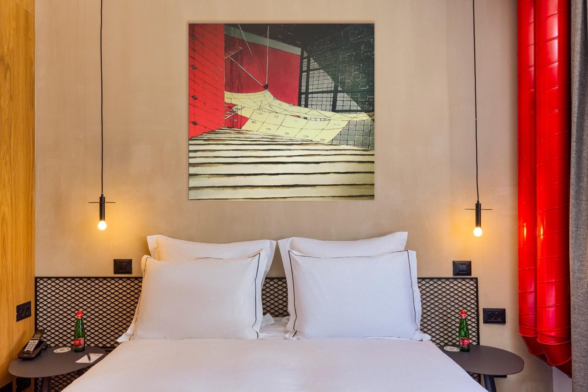 A hotel room with a large bed, two bedside tables, a wall-mounted painting, and a red curtain.