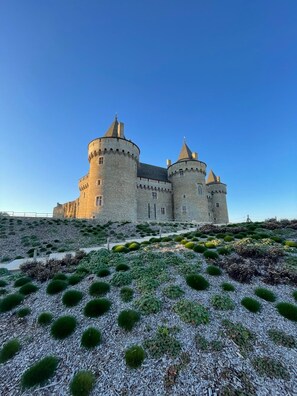 A castle with multiple towers and a surrounding landscaped area with shrubs. - Family home on the outskirts of Vannes and near the Morbihan Golf Course (Locmaria-Grand-Champ)