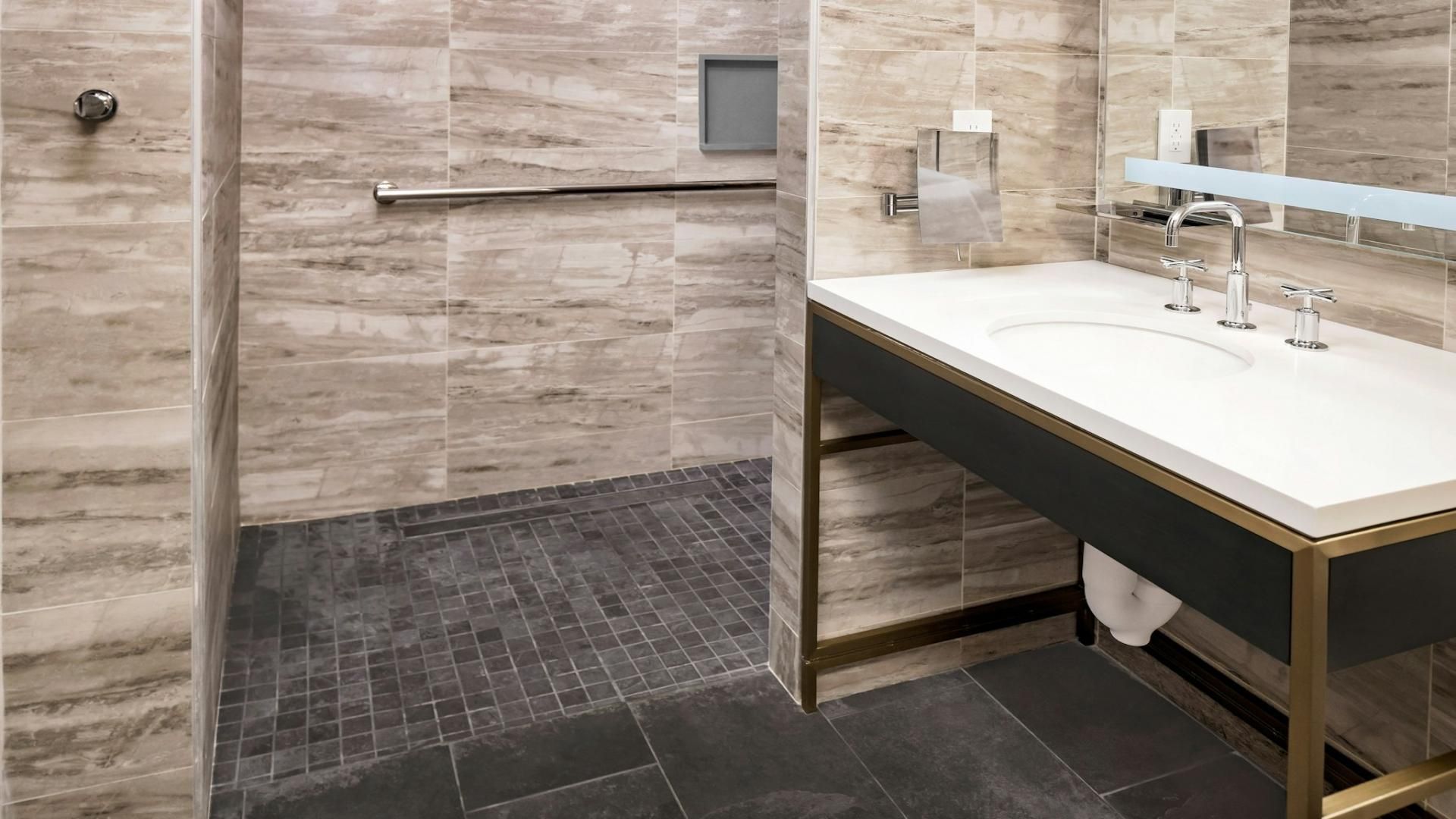 A modern bathroom with a shower, a vanity with a sink, and a mirror.