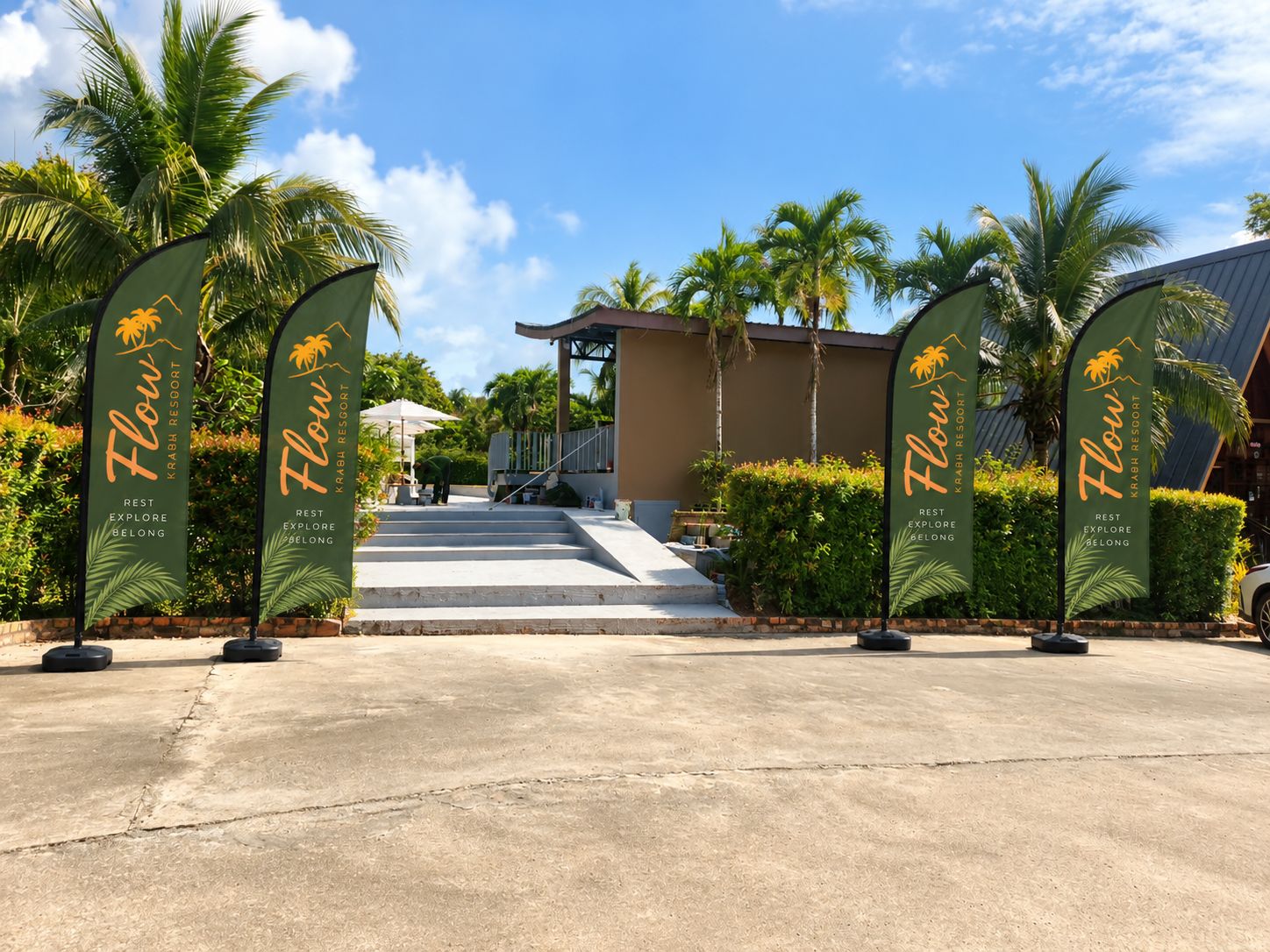 A resort entrance with palm trees and a clear sky.