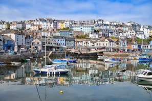 A harbor with boats, a bridge, and colorful buildings. - Finest Retreats | Greenswood (Brixham)
