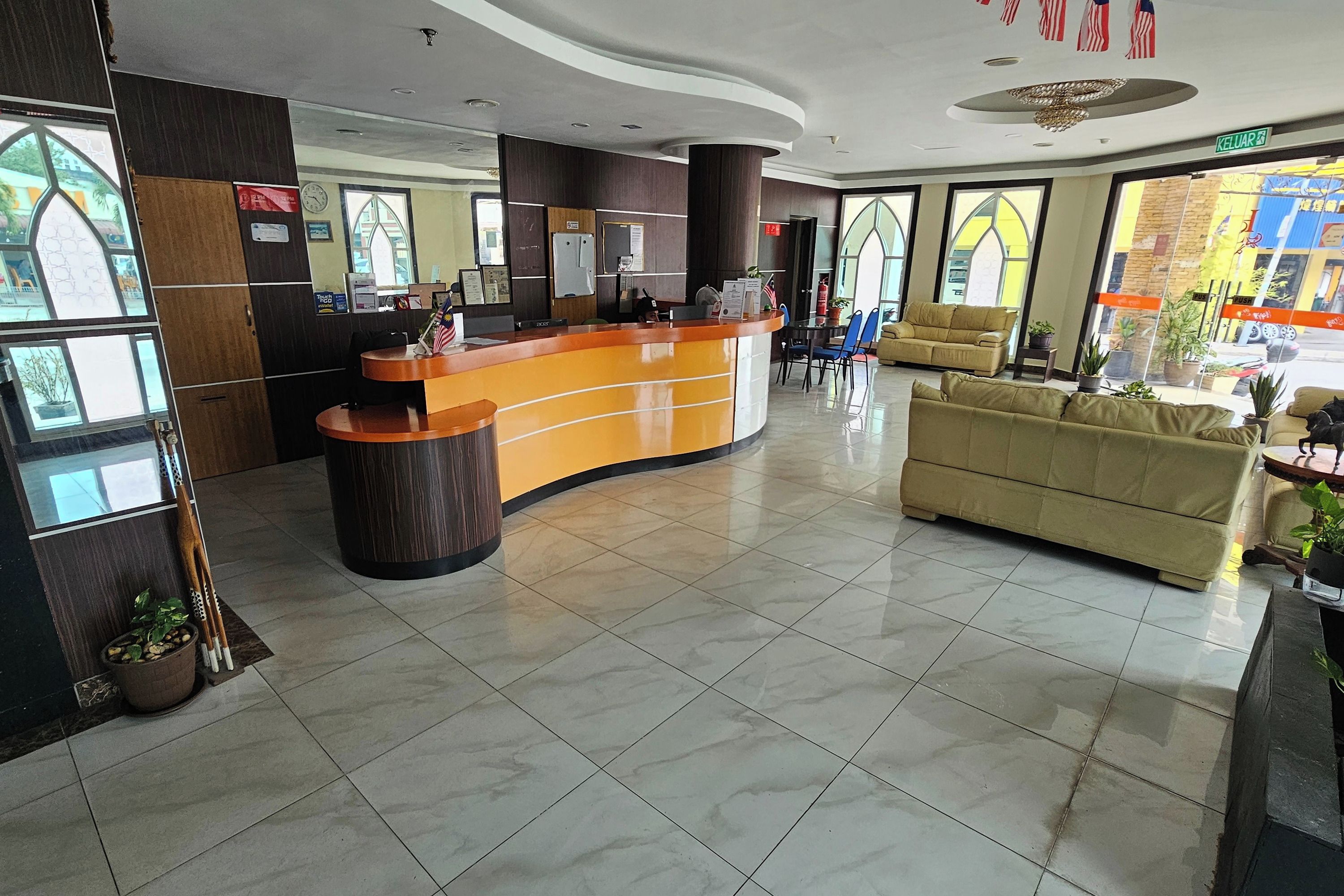 A reception area with a curved counter, a sofa, and a coffee table.