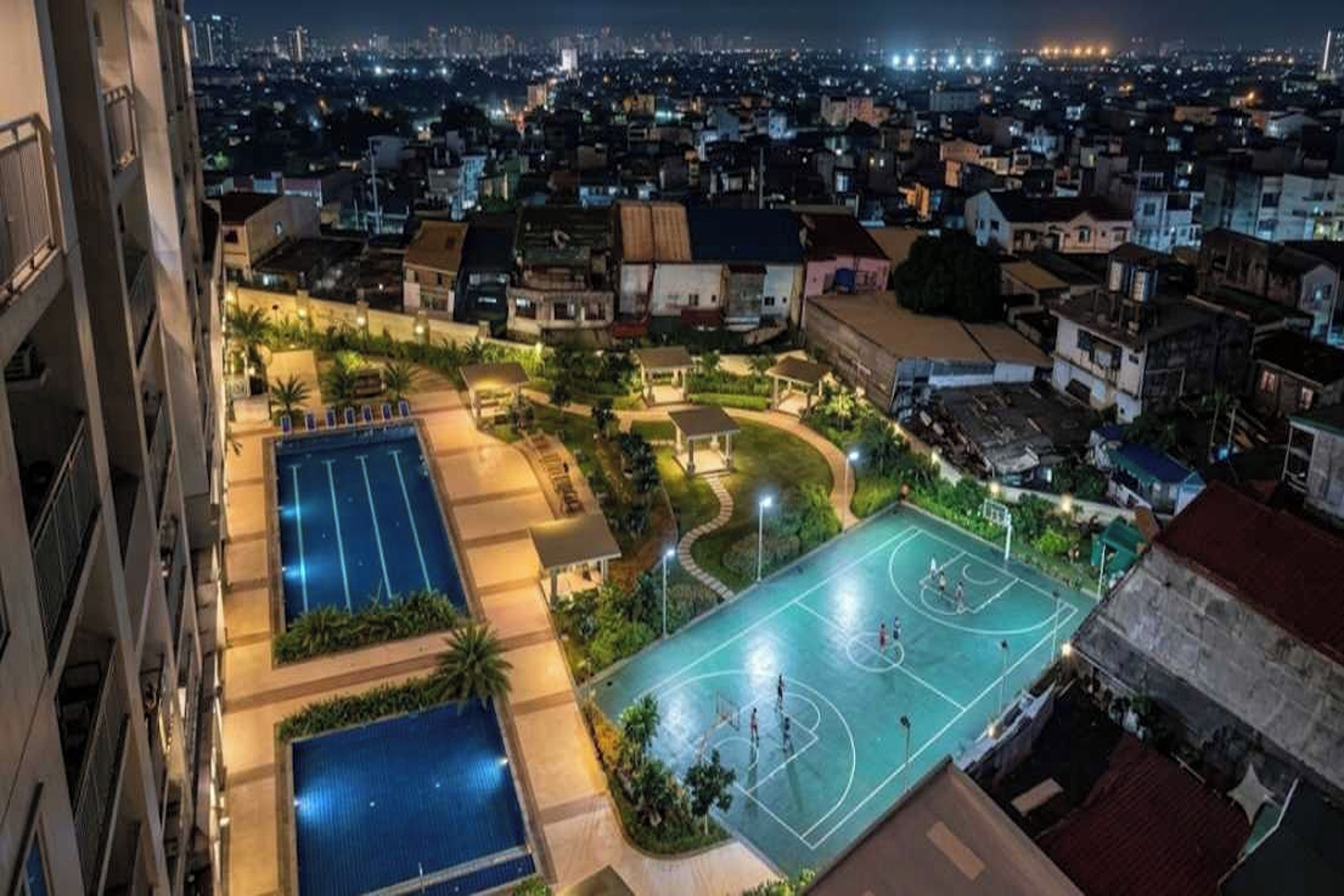 A residential area with a basketball court, a swimming pool, and a tennis court.