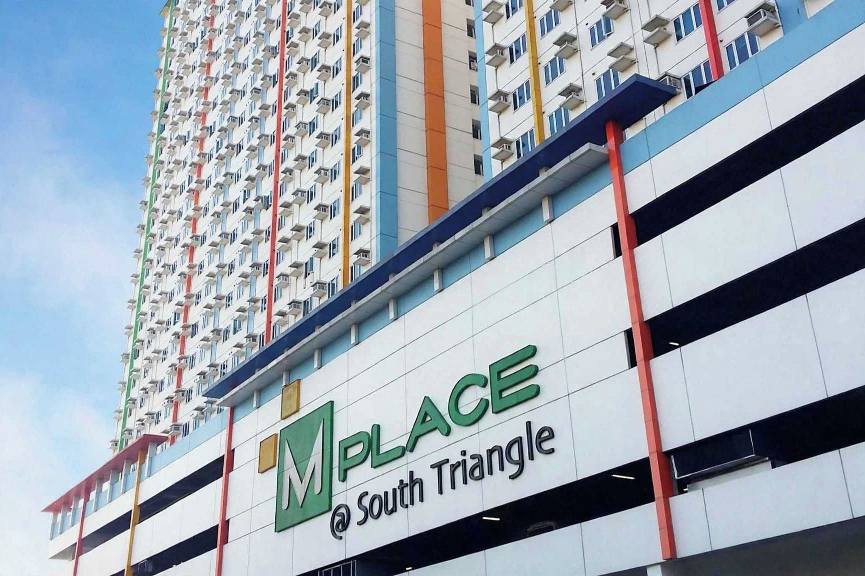 A multi-story building with a sign that reads 'PLACE @ South Triangle'.