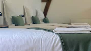 A bedroom with a bed, pillows, and a folded towel.