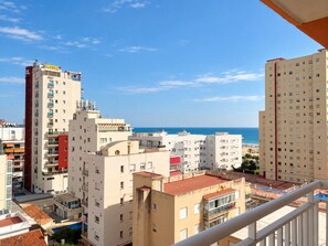 A hotel with multiple floors, balconies, and a view of the sea. - El Tiburón 8º Solo Familias! (Playa de Gandía)