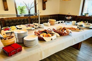 A buffet setup with various food items and serving utensils. - Holiday apartment with 1 bedroom (Oy-Mittelberg)