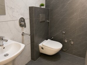 A bathroom with a white sink, a toilet, and a shower area. - Collection O Guru Nanak Dev University (Amritsar)