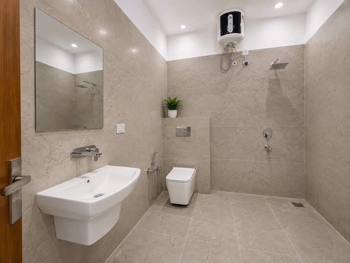 A modern bathroom with a built-in sink, a toilet, and a shower area.