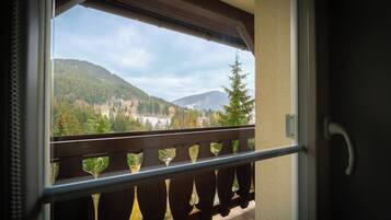 A balcony with a view of a mountainous landscape.