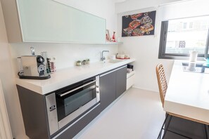 A modern kitchen with a built-in oven, a sink, and a window providing natural light. - Stunning Premium Villa, beaches within walking distance via Groom* (Larmor-Plage)