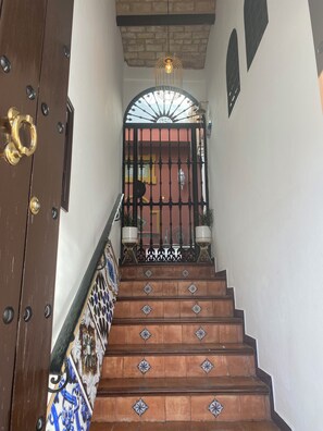 A staircase with ornate railings and a decorative door with a brass handle. - Boutique-Eros House (Carmona)