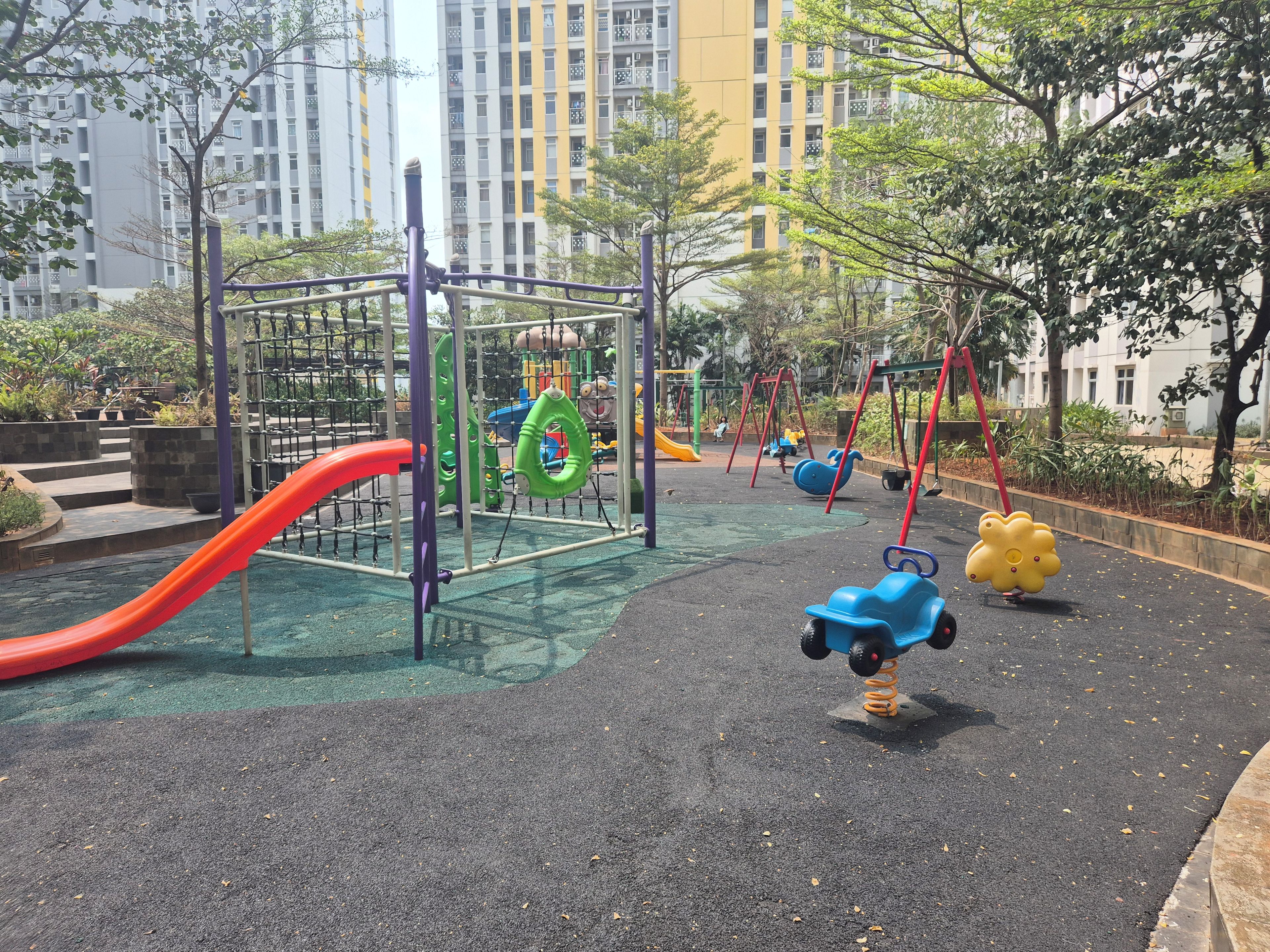 A playground with a slide, swings, and climbing structures.