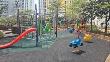 A playground with a slide, swings, and climbing structures.