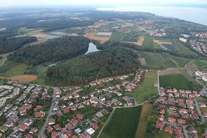 An aerial view of a residential area with houses, roads, and fields. - Bernhard Winery Type B (Daisendorf)