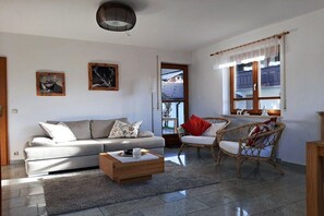 A living room with a sofa, chairs, a coffee table, and artwork on the walls. - Holiday apartment with 3 bedrooms (Rettenberg)