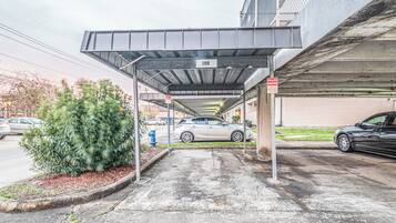 Eine Parkgarage mit überdachtem Bereich, Kennzeichnung 198, einem Feuerhydranten und einem Auto, das unter der Überdachung steht.