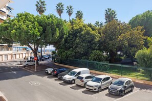 A parking lot with several cars, a no entry sign, and a building with balconies in the background. - 3 bedrooms, 2 bathrooms, balcony, garage A3B139 (Cannes)