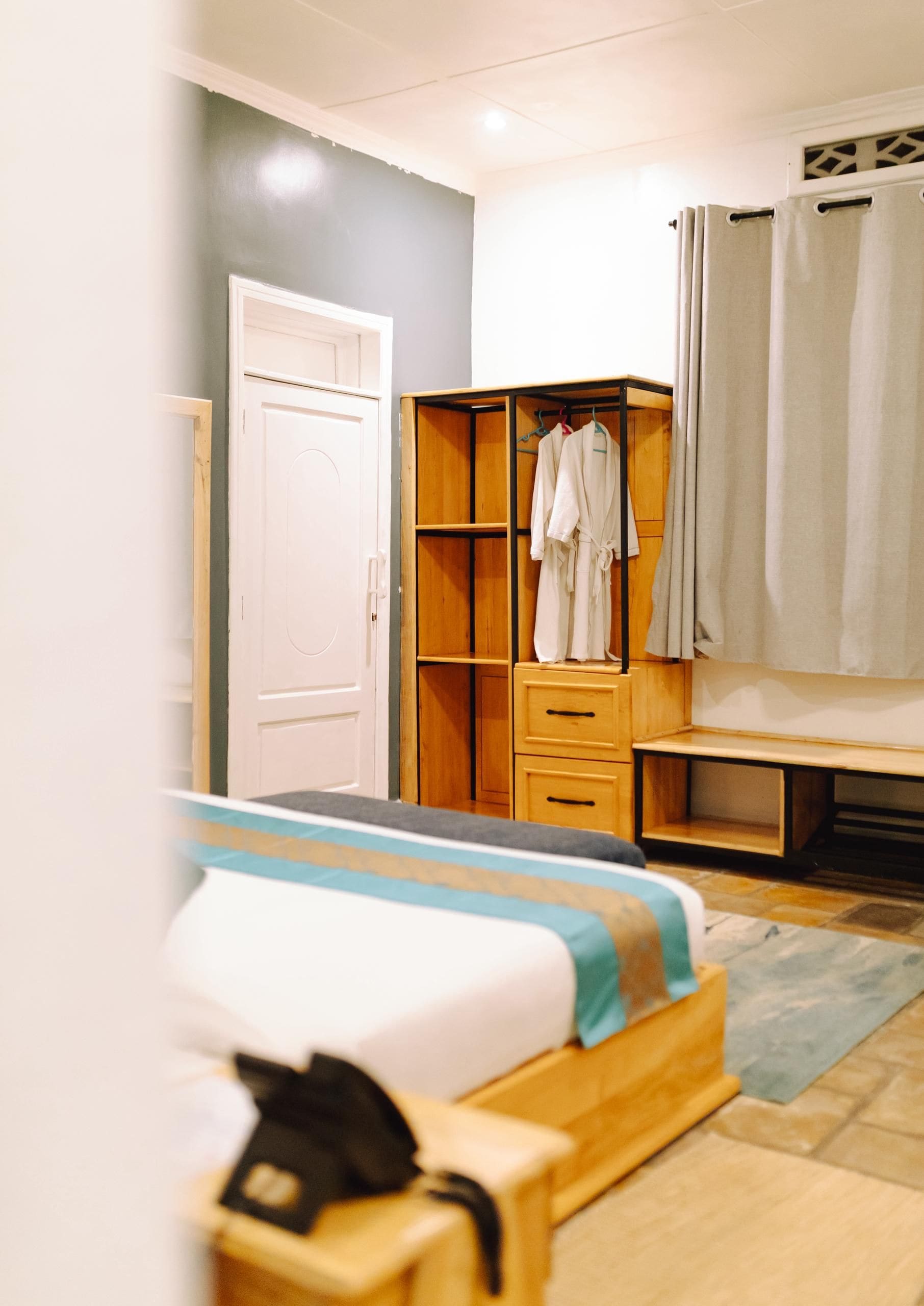 Un dormitorio con cama, armario y baño.