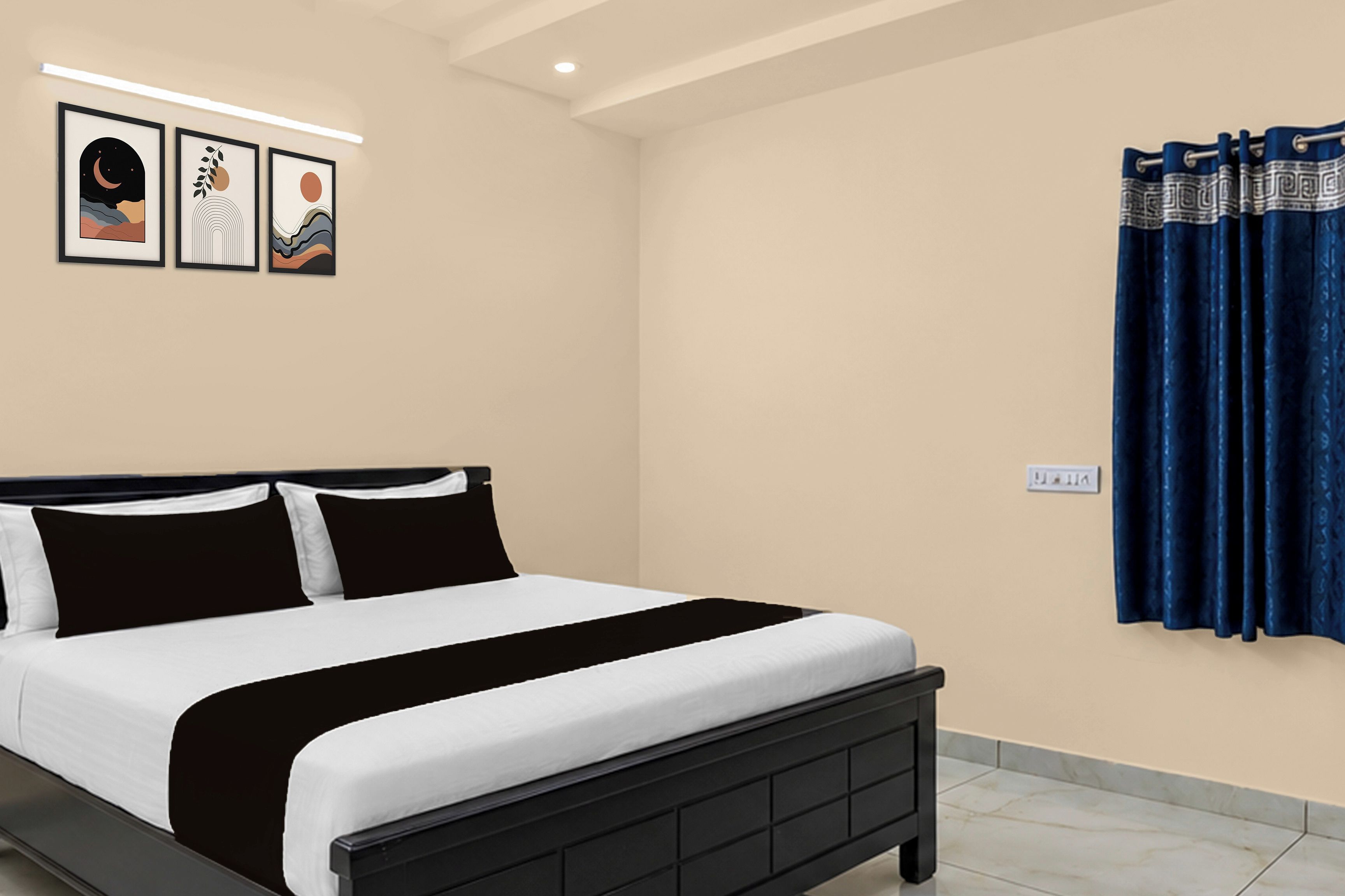 A bedroom with a bed, a wall-mounted light, and a power outlet.