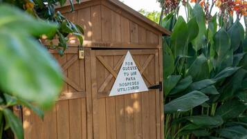 A wooden shed with a sign indicating it is for guests to use for guests.