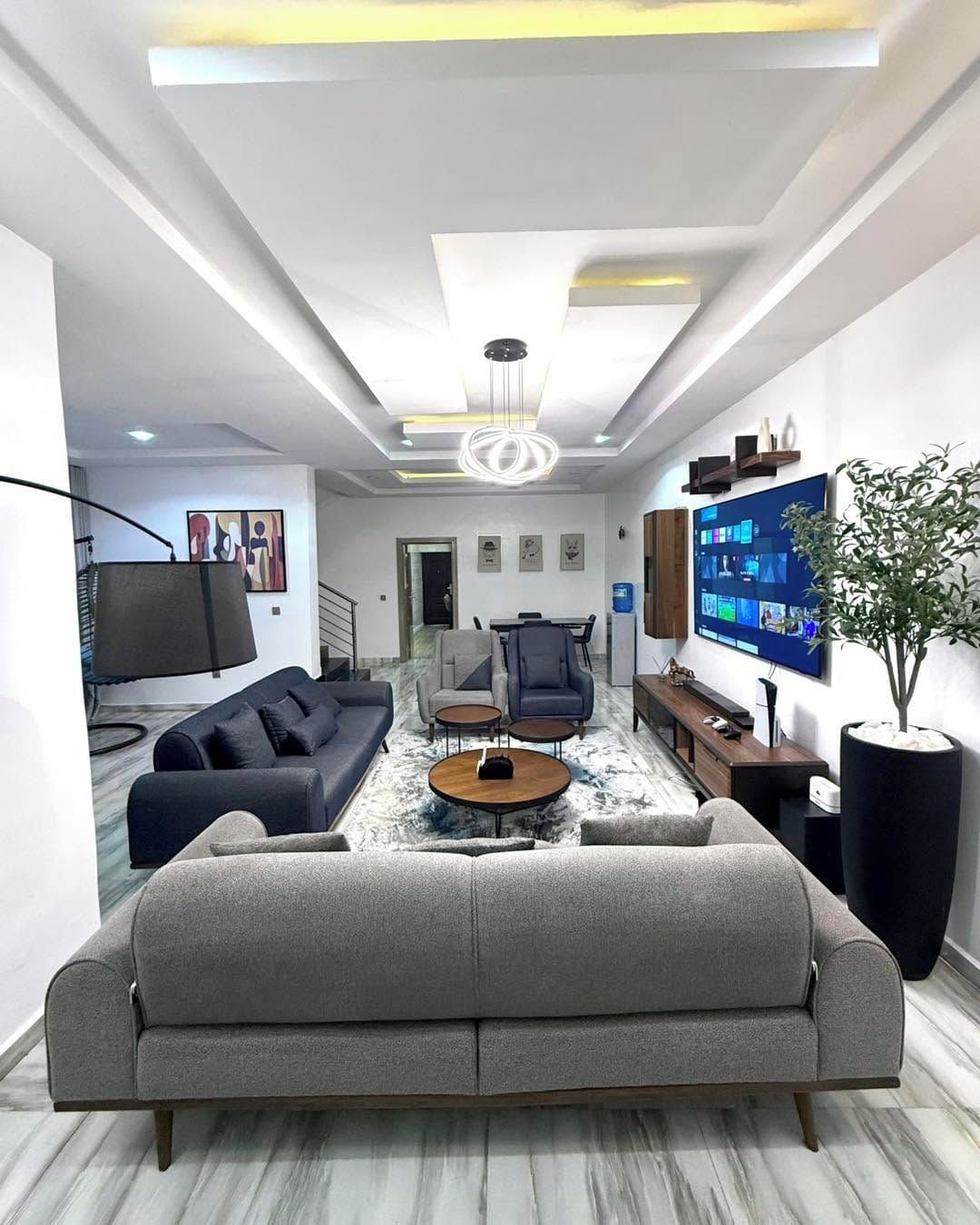 A modern living room with a sofa, coffee table, and TV.