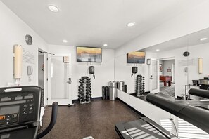 A gym with exercise equipment, a treadmill, and a mirrored wall. - 2x2BR Condos, Winter Escape Near the Mountains (Leavenworth)