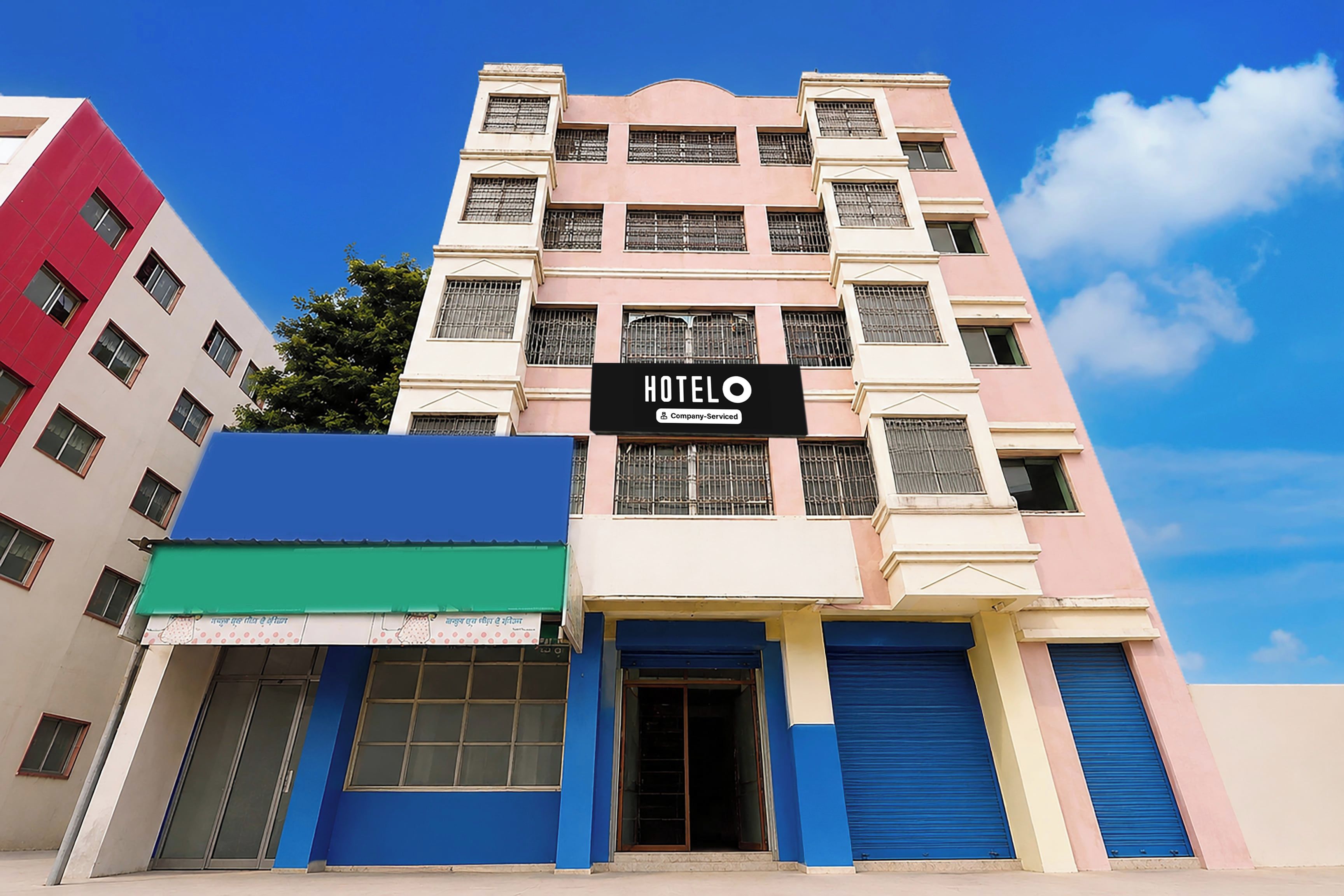 A multi-story hotel building with a sign that reads 'HOTEL'.