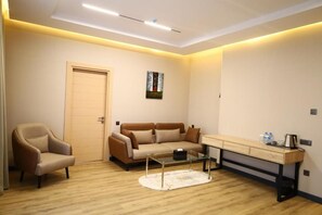 A modern living room with a sofa, armchair, coffee table, and a desk with drawers. - Gacha Gooch Forest (Qusar)