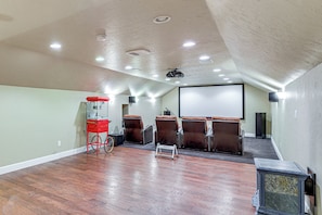 A home theater room with a large screen, reclining chairs, a popcorn cart, and a projector. - Mtn-View Ranch Near Black Canyon Nat'l Park (Crawford)