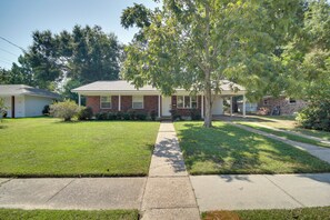 A residential house with a front lawn, a pathway leading to the entrance, and a tree providing shade. - < 2 Mi to Beach! Home w/ Fenced Yard in Gulfport (Gulfport)