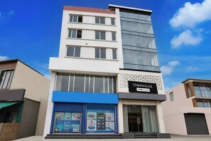 A multi-story building with a sign indicating it is a townhouse. - Townhouse Old Railway Road (Gurugram)