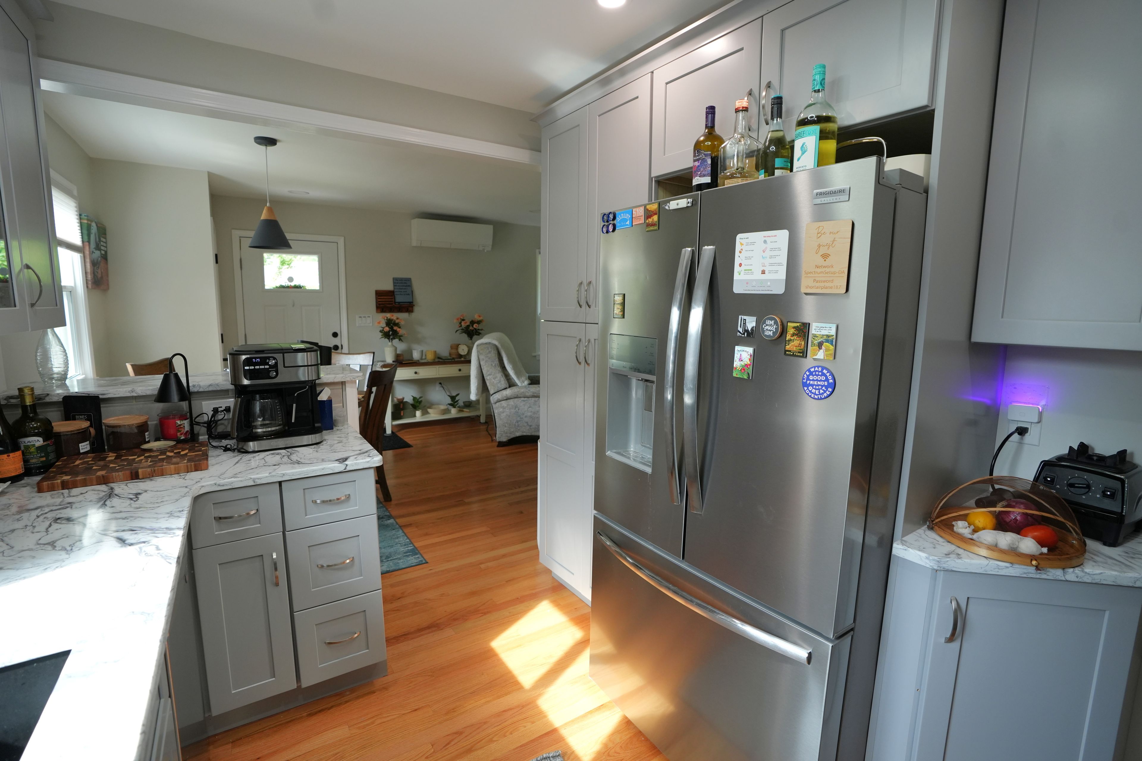 A modern kitchen with a built-in refrigerator, coffee maker, and various kitchen appliances.