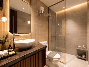 A modern bathroom with a large sink, toilet, and shower area. - KAS Dilly Luxury Hotel (Ho Chi Minh)
