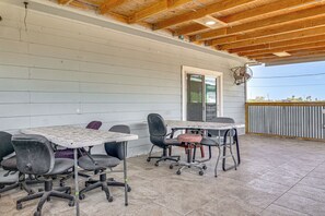 An outdoor patio area with two tables and four chairs, a wooden ceiling, and a view of the surrounding landscape. - San Benito Home w/ Pool, Close to Dtwn (San Benito)