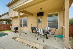 A covered patio area with a table and chairs, a grill, and a pool. - 7 Mi to SeaWorld! Group-Friendly Getaway w/ Pool (San Antonio)