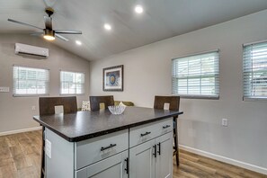 A kitchen with a central island, built-in cabinets, and a ceiling fan. - *New To Market* | Riverfront Pigeon Forge Retreat (Pigeon Forge)