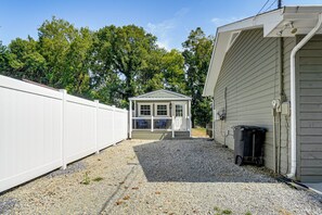 A residential property with a fenced backyard, a small shed, and a utility shed. - *New To Market* | Riverfront Pigeon Forge Retreat (Pigeon Forge)