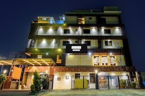 A multi-story hotel with a sign reading 'PALETTE OVO-Serviced.'