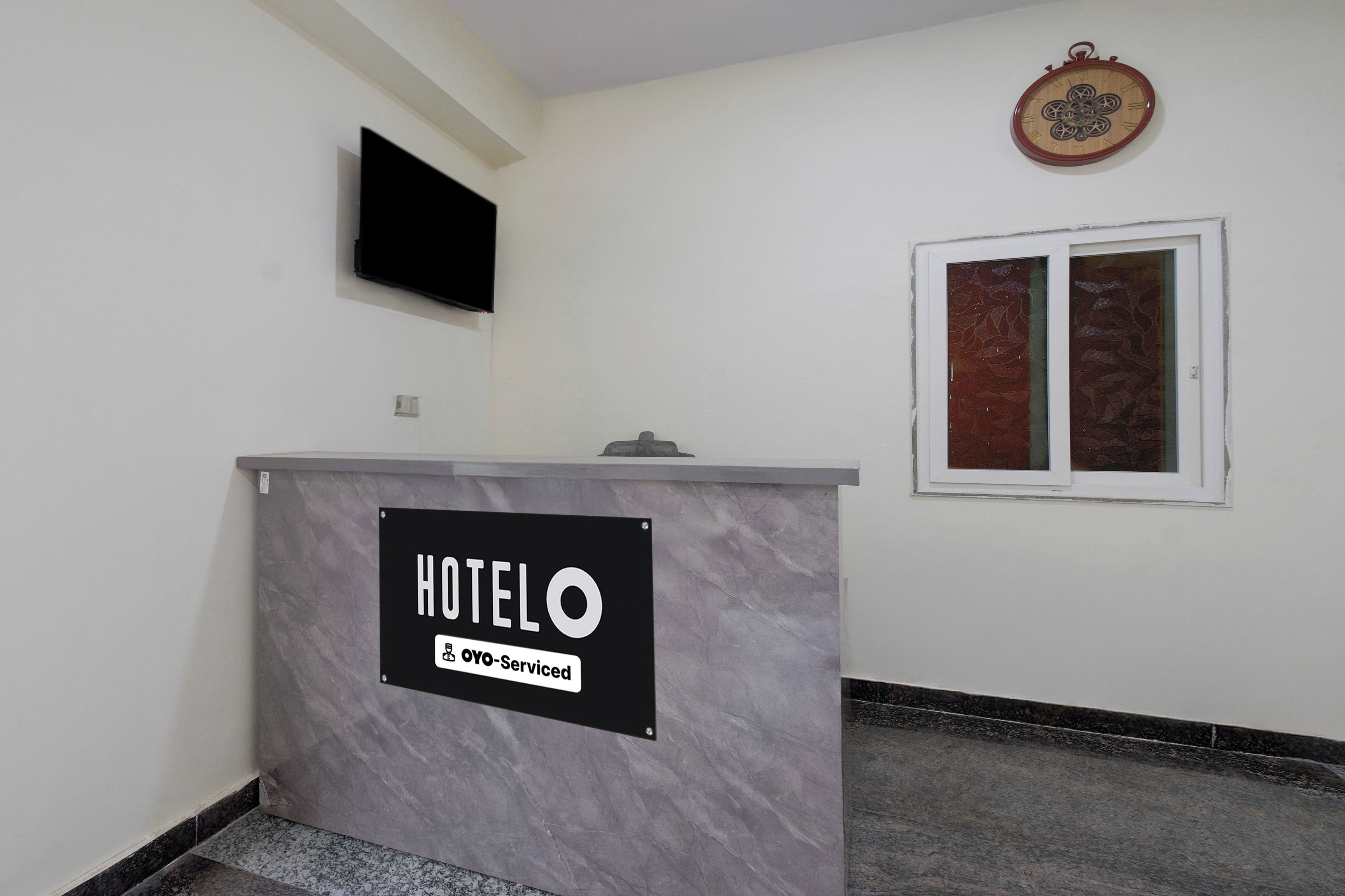 A reception desk with a sign that reads 'HOTEL' and 'YO-Serviced.'