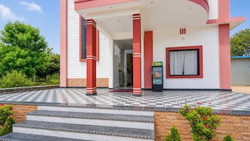 A modern building with a checkered floor, a balcony, and a vending machine.