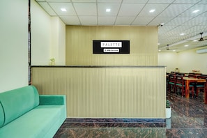 A reception area with a sign reading 'PALETTE' and a green sofa. - Palette Mansarover Extension (Jaipur)