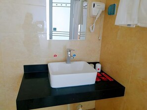 A bathroom with a white sink, a mirror, a hairdryer, and a telephone. - Thank Inn Hotel Hebei Zhangjiakou Wanquan County Kongjiazhuang Bus Station (Zhangjiakou)