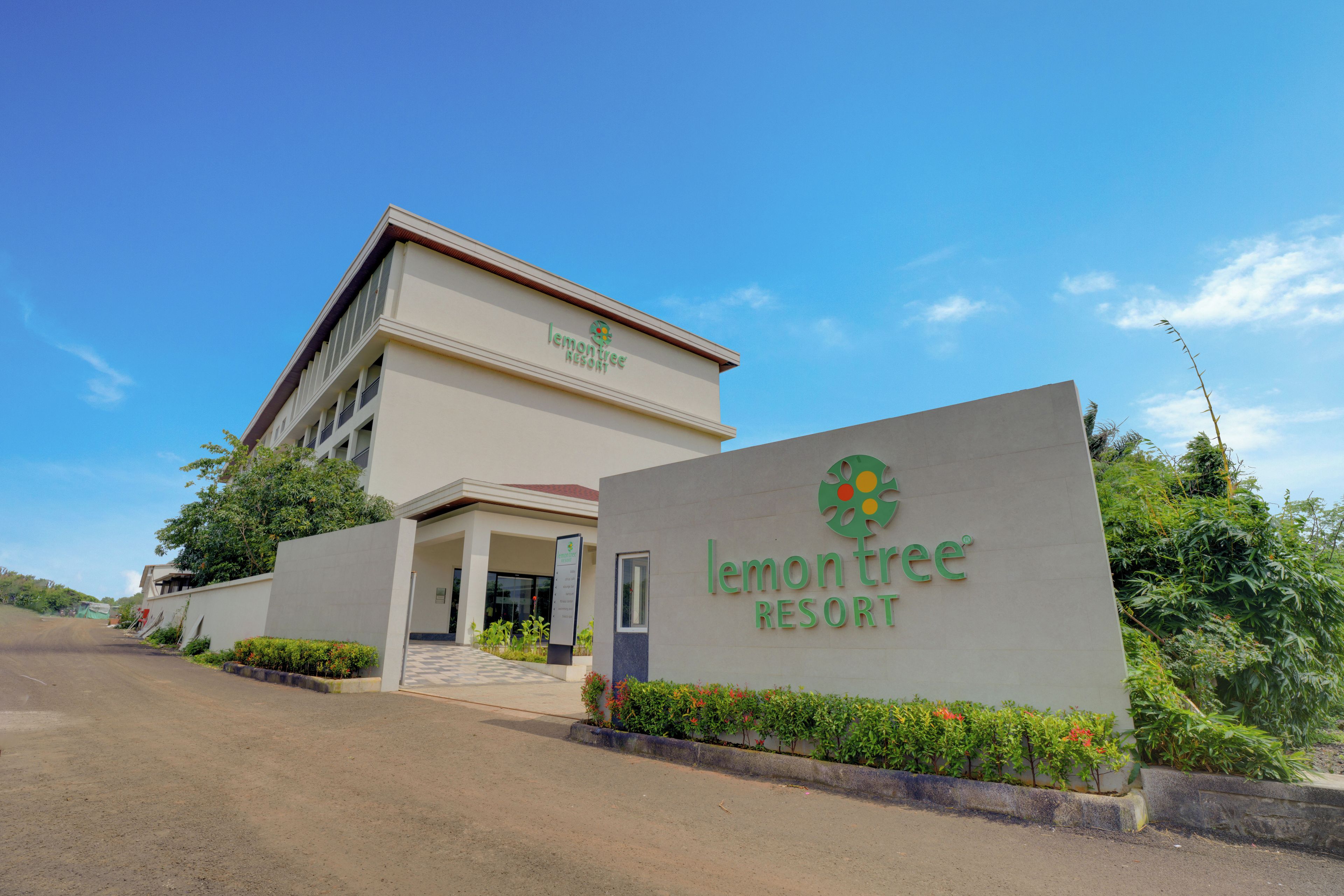 A building with a sign reading 'lemon tree resort'.