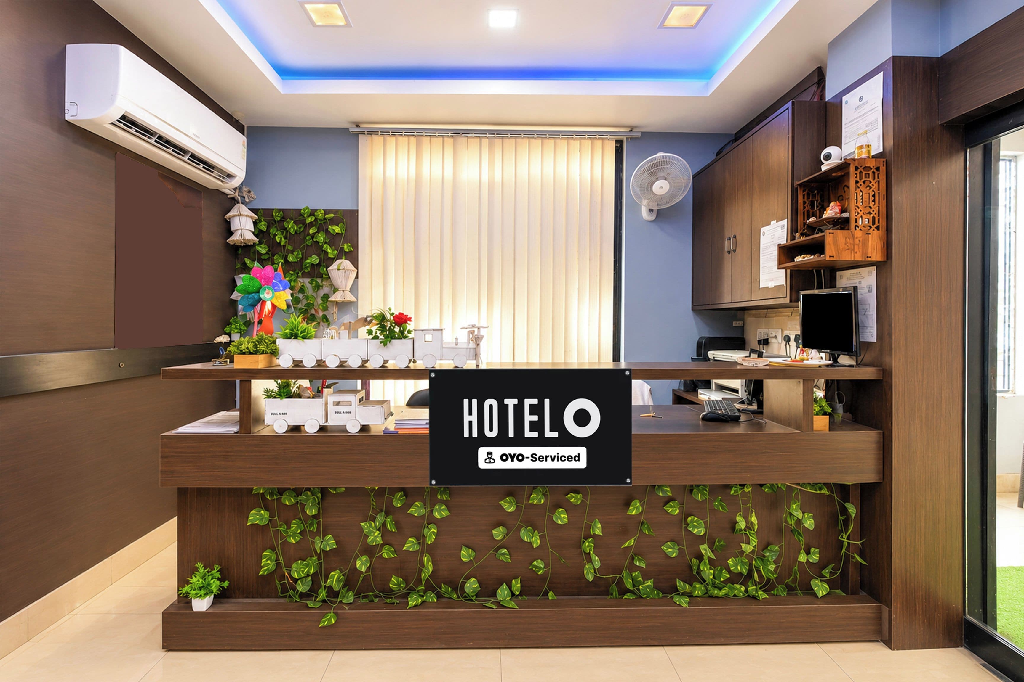 A hotel reception desk with a sign indicating it is self-service.