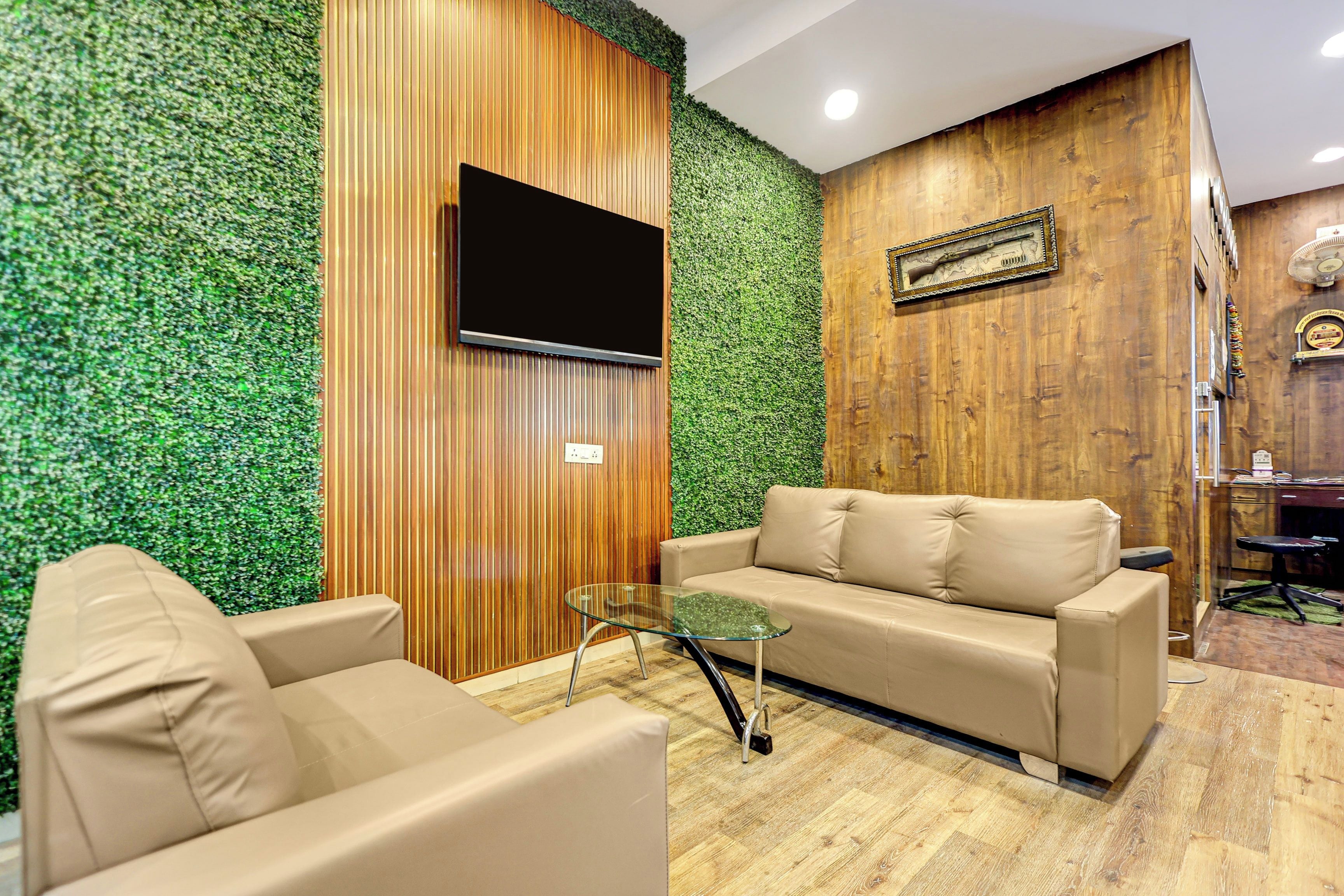 A modern living room with a sofa, armchair, and glass coffee table.
