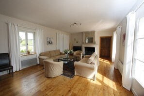 A living room with a sofa set, a coffee table, a fireplace, and a television. - Charming house in Quercy – private heated pool (15×6 m) and separate guesthouse (Roquecor)