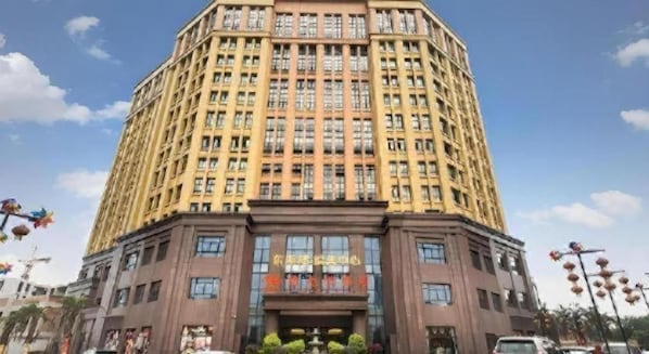 A multi-story hotel with a prominent entrance and a large sign. - Vienna Hotel (Chengdu)
